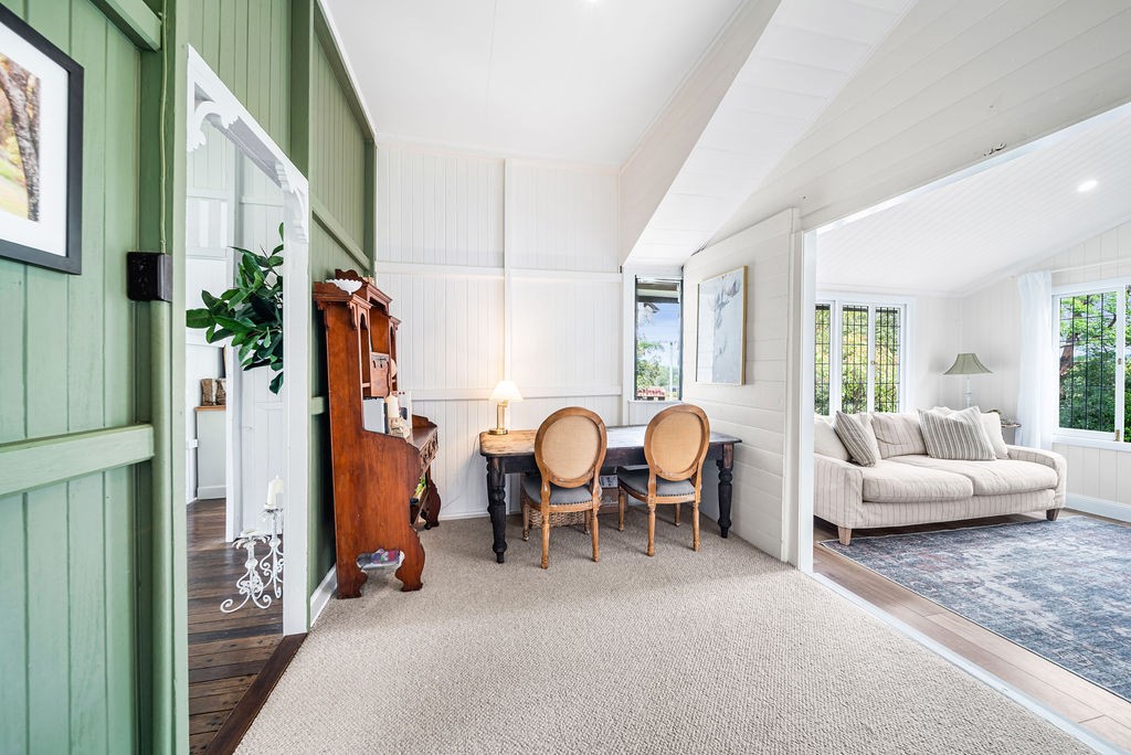 The original living room after renovation, with green accent doors leading into lighter rooms.